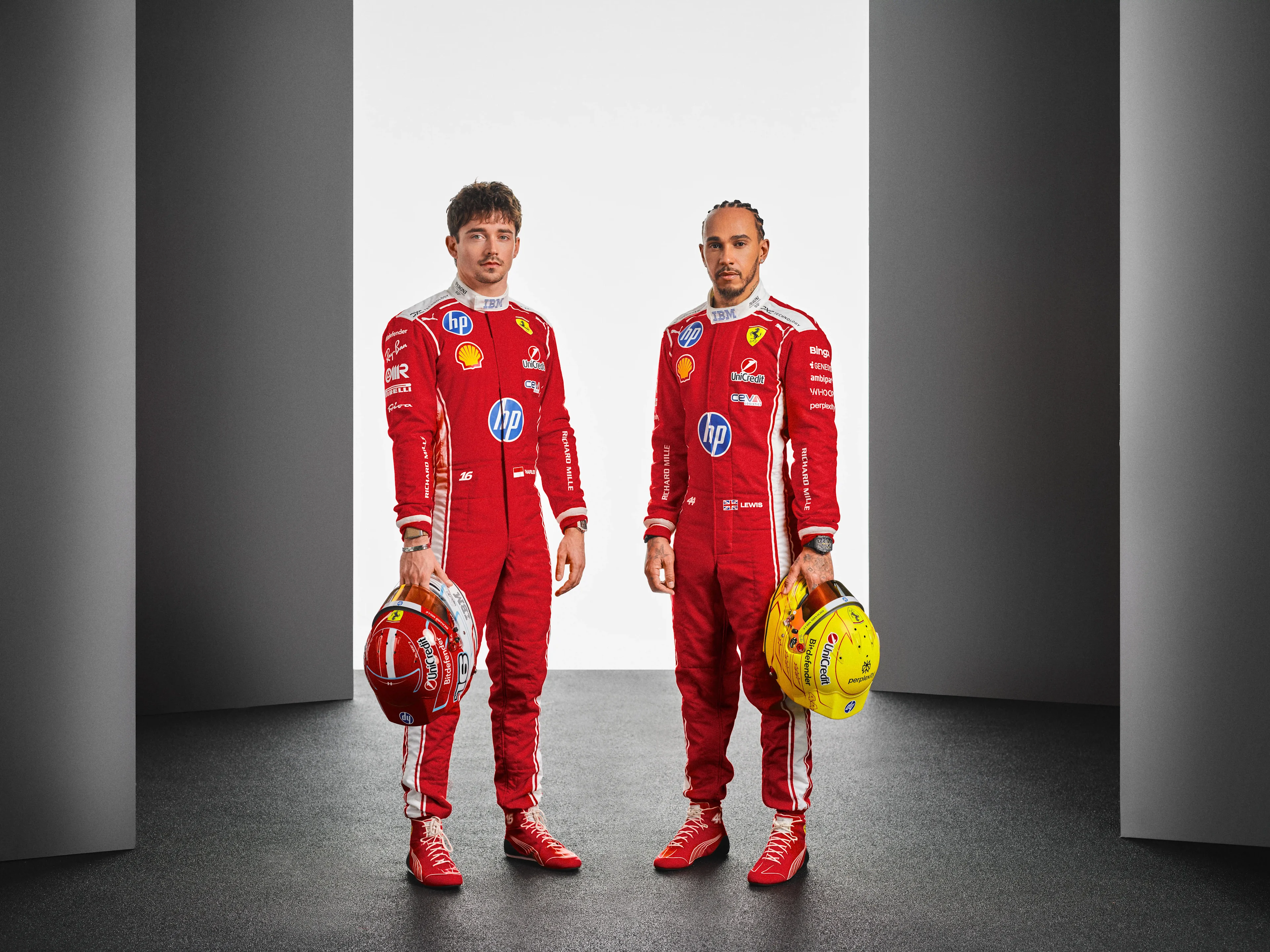 Scuderia Ferrari Formula 1 drivers in full race suits holding their helmets, representing elite performance, recovery optimization, and WHOOP partnership in professional motorsport.