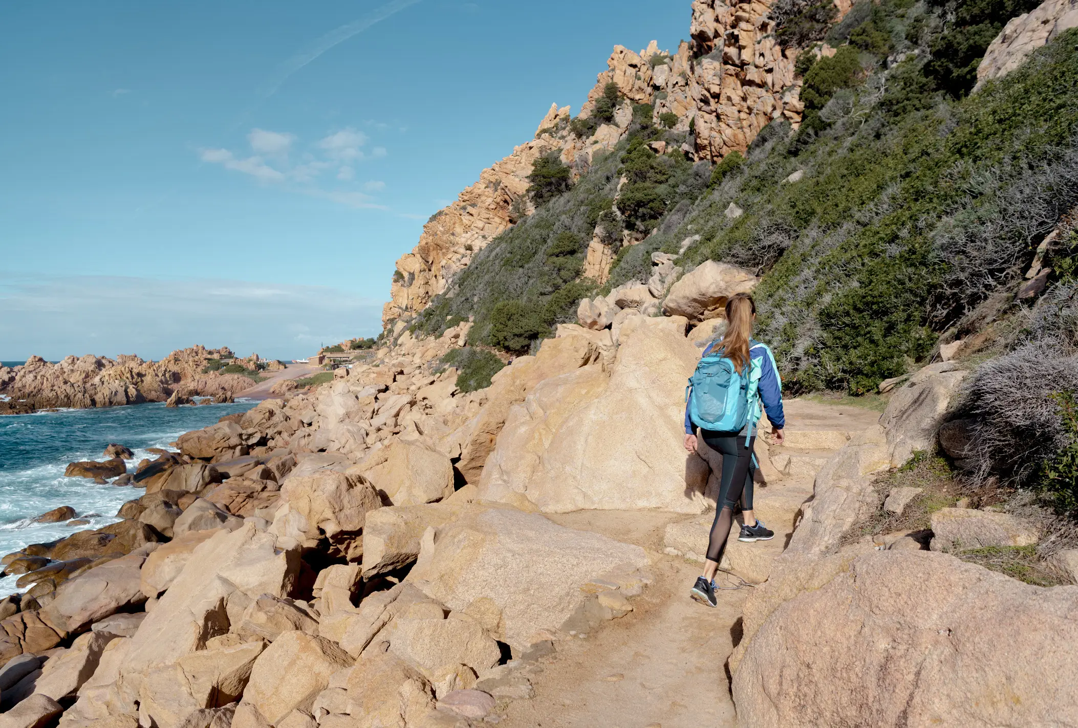 Italy, Sardinia, Spiaggia di Li Cossi A tourist walks to Spiaggia di Li Cossi in Sardinia, Italy.