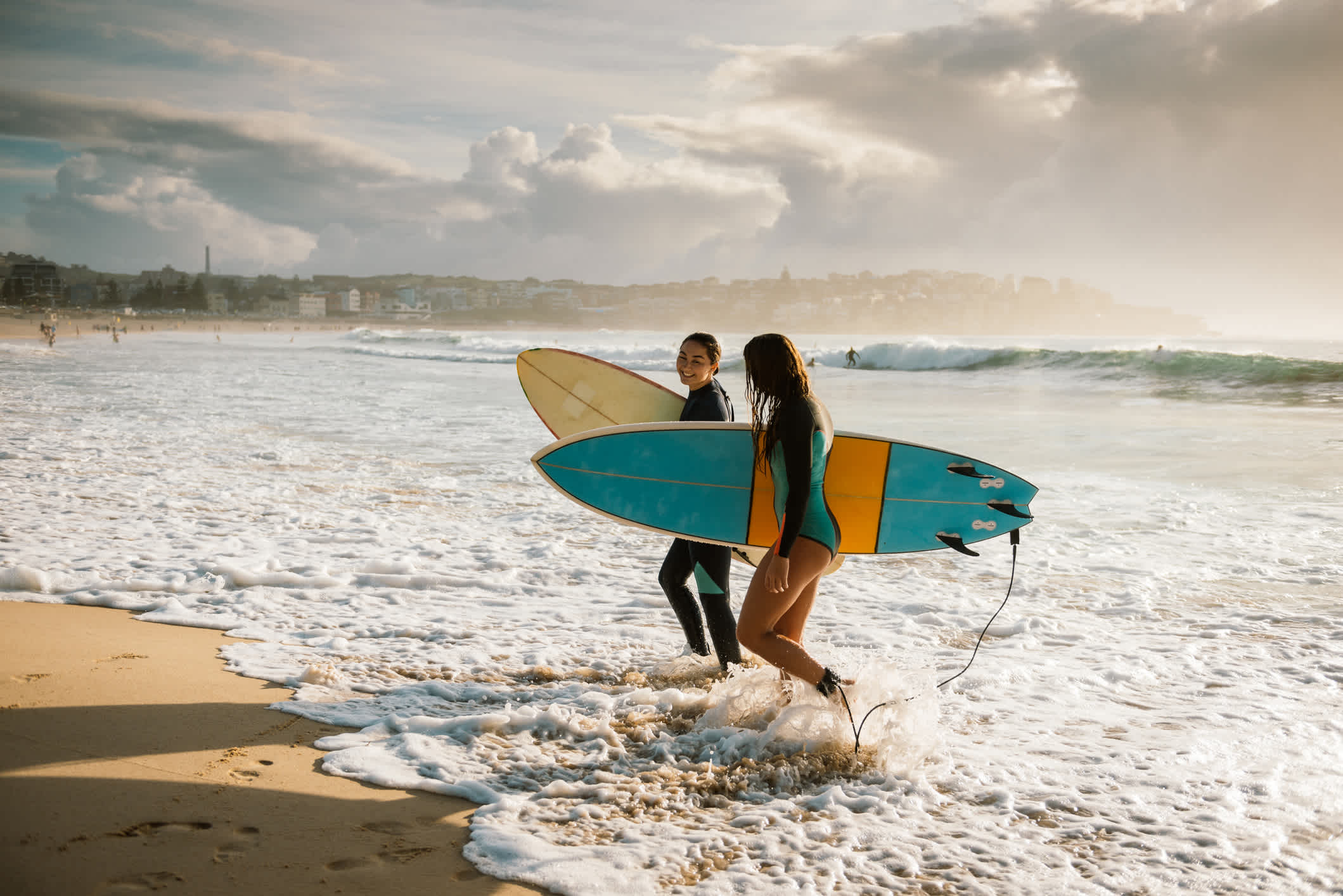 Zwei Surferinnen am Strand von Sydney, Australien.