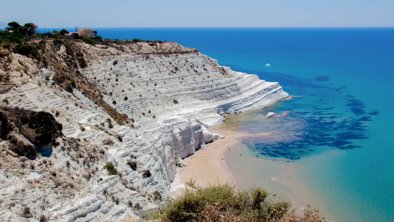 The Scala dei Turchi in Sicily is an impressive rock formation made of white limestone that drops steeply down to the turquoise sea and offers a breathtaking view