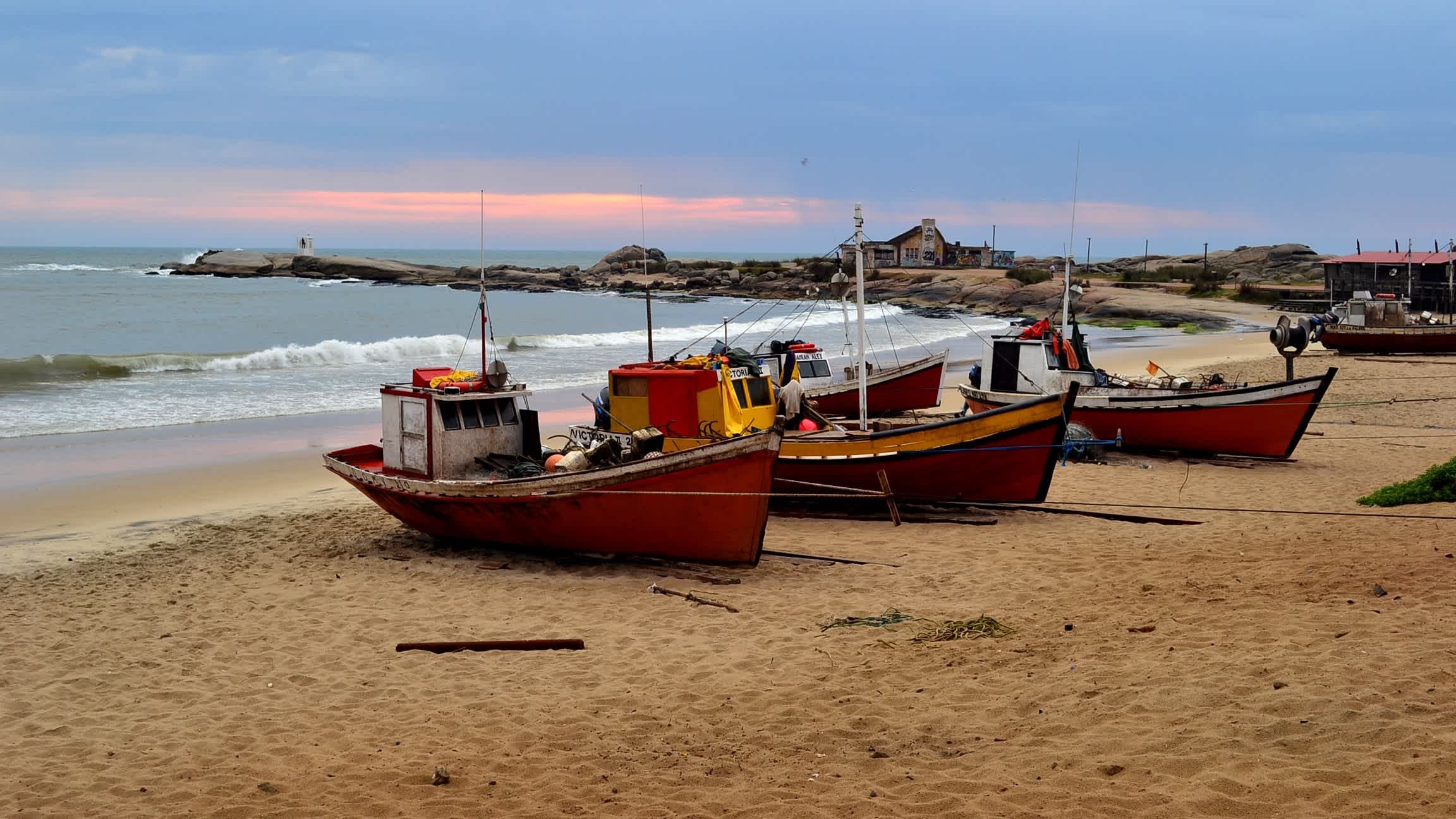 Fischerboote auf dem Playa de los Pescadores, Punta del Diablo, Uruguay bei Sonnendämmerung.
