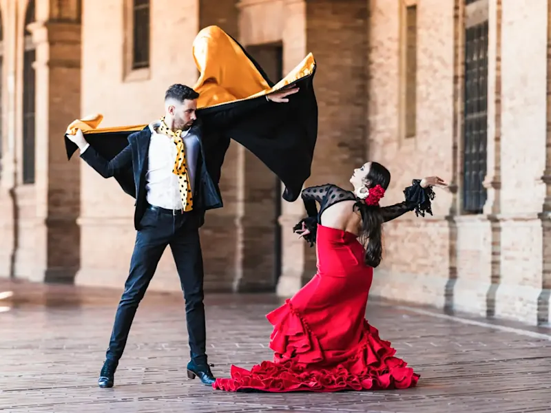 Spain, Seville, Flamenco Man and woman in flamenco costumes lead in Seville