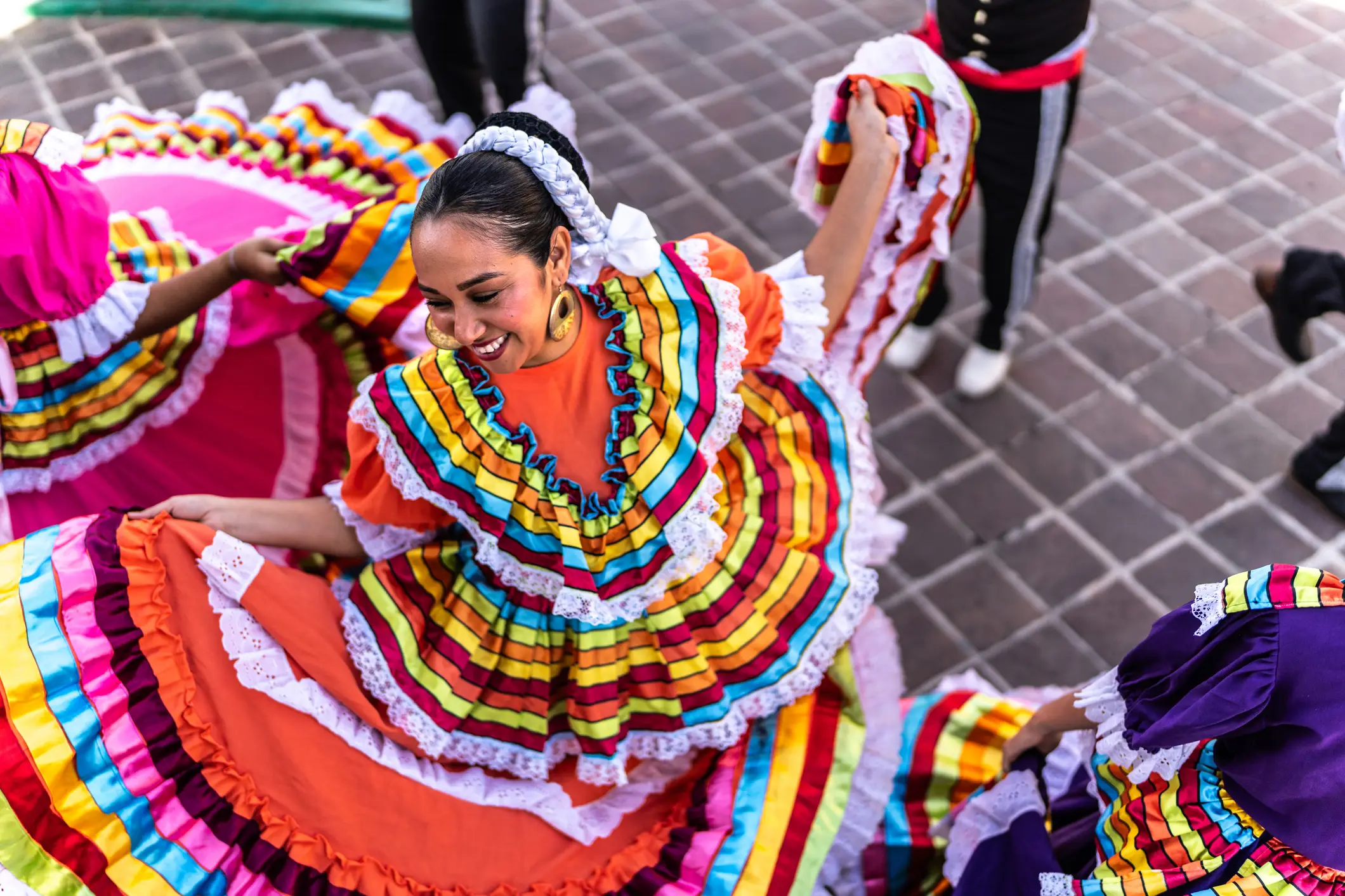 Middle aged adult woman dancing in traditional festival in public park, Mexico.