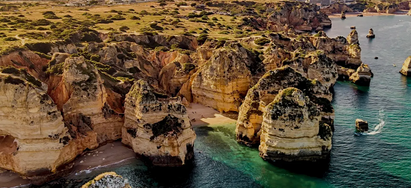 Cliffs with small beaches and crystal-clear water, Lagos, Algarve, Portugal.