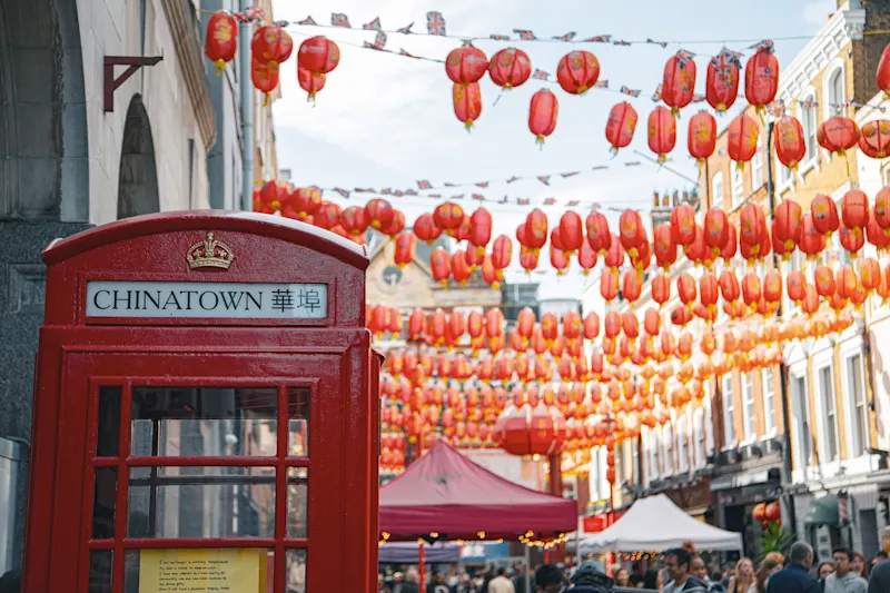 Chinatown, London, England Red telephone box in Chinatown, with red banners, London, England