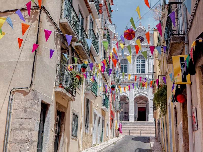 Colorful alleys with garlands in the historic quarter, Lisbon, Lisbon, Portugal.