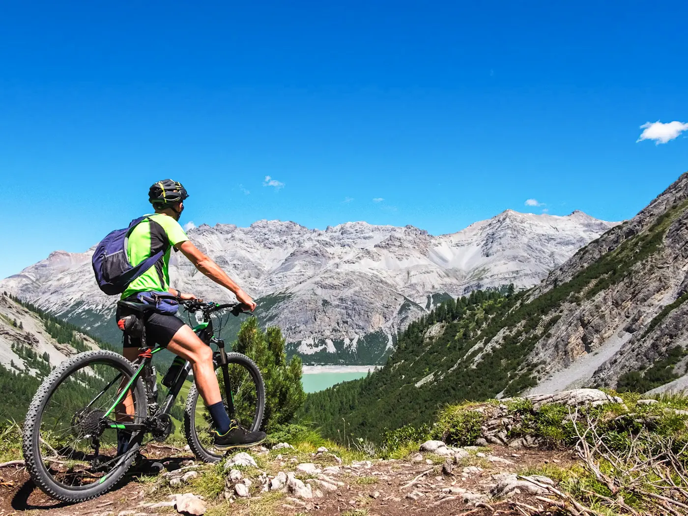 Un vététiste apprécie la vue imprenable sur les Alpes, Livigno, Lombardie, Italie.