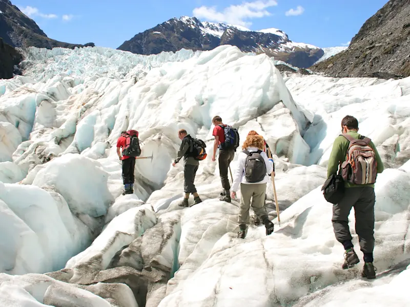 Neuseeland, Südinsel, Franz-Josef-Gletschers Wanderer erkunden die eisige Landschaft des Franz-Josef-Gletschers, Franz Josef, Südinsel, Neuseeland.