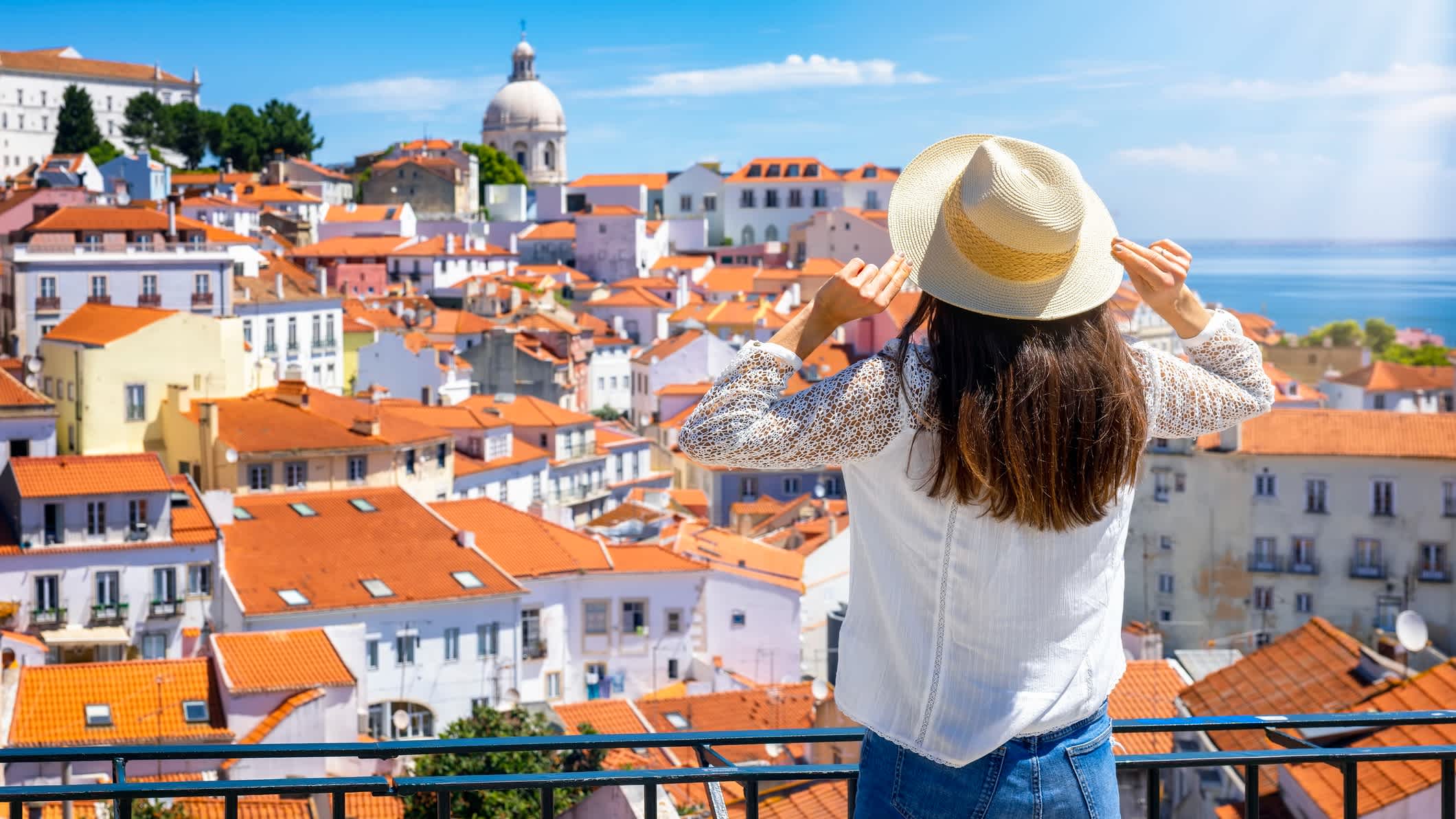 Eine Touristin blickt auf das wunderschöne Stadtbild von Lissabon, Portugal