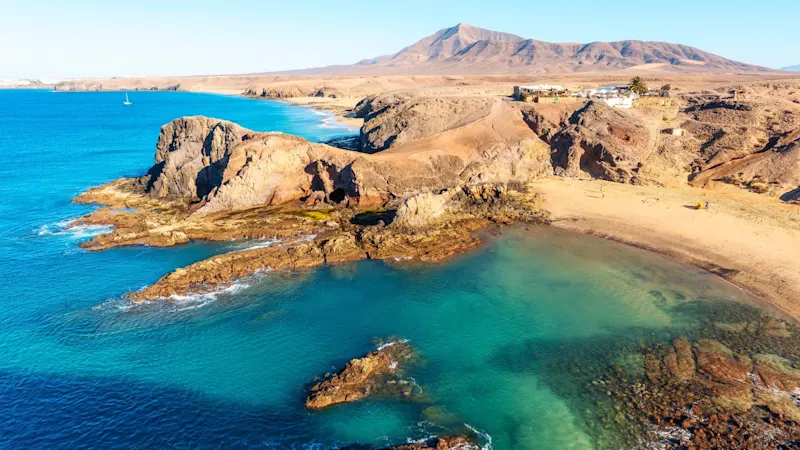 Wüstenlandschaft und blauer Himmel am Meer