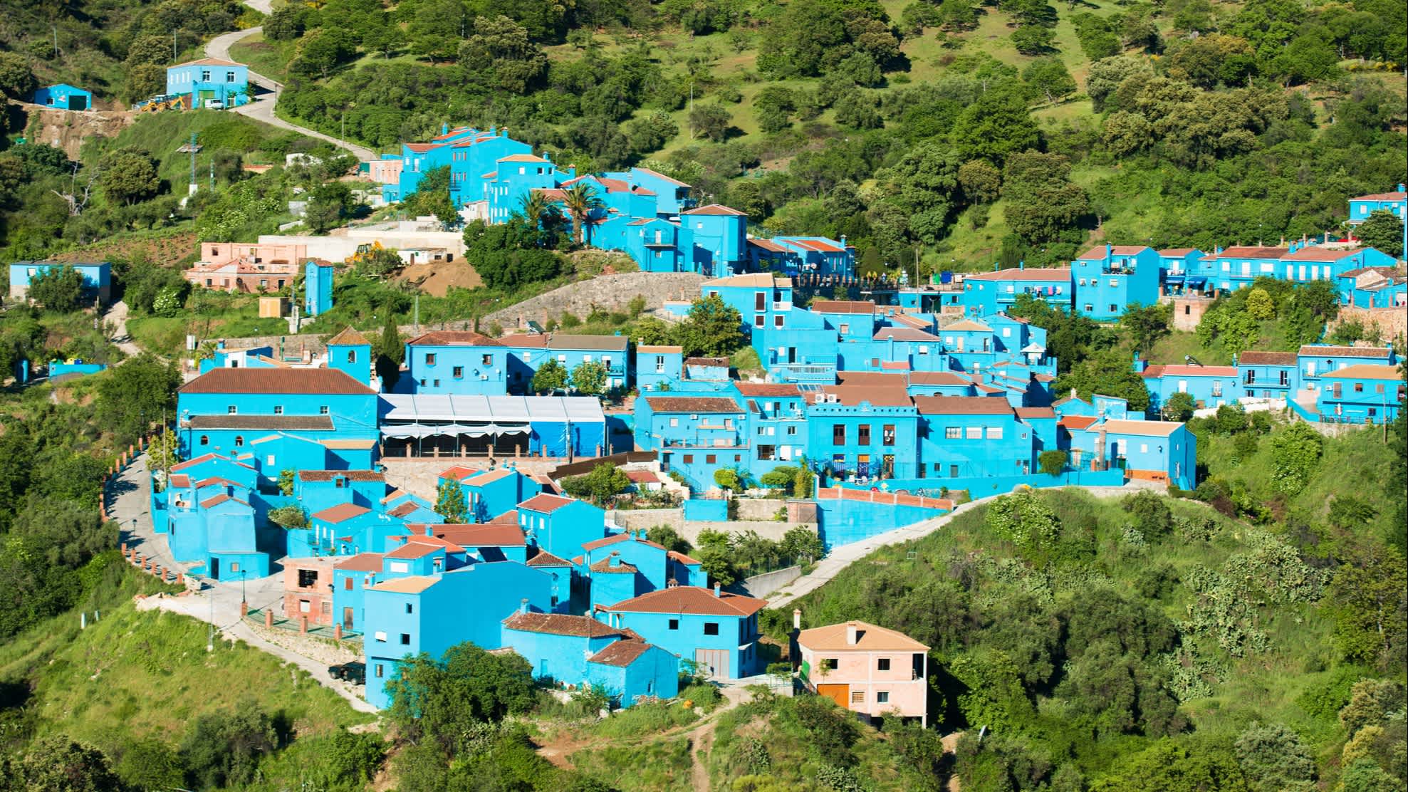 Discover the beautiful blue town of Juzcar, pictured here from above, on a tour of Spain