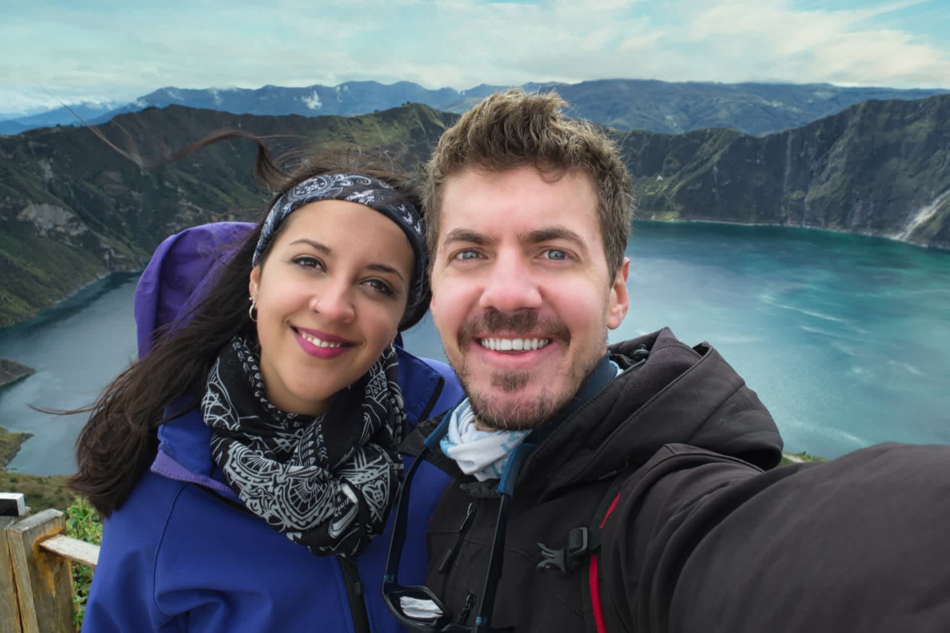 Ein Reisepaar macht ein Selfie am Quilotoa-See im Inneren eines Vulkankessels in Ecuador.
