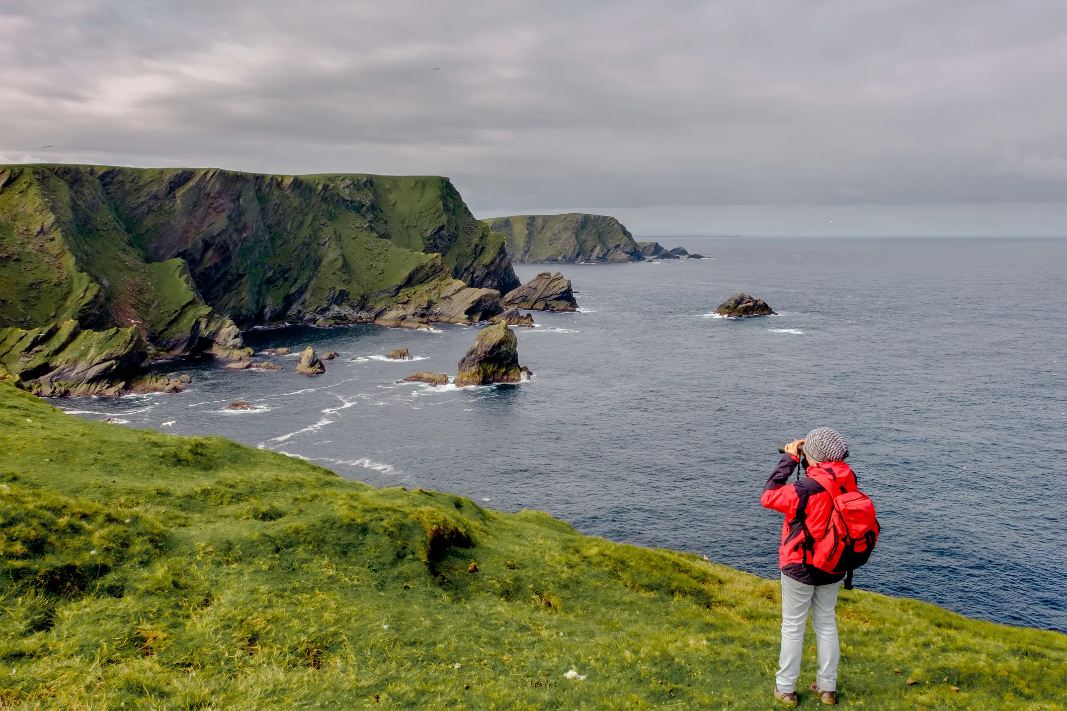 Hiker on the island of Unst, Shetland Islands, Scotland.