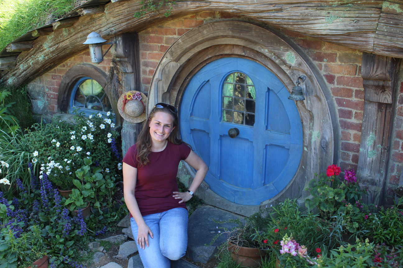 Deborah Clauss, devant la porte d'une maison de hobbit, Hobbiton, Nouvelle-Zélande