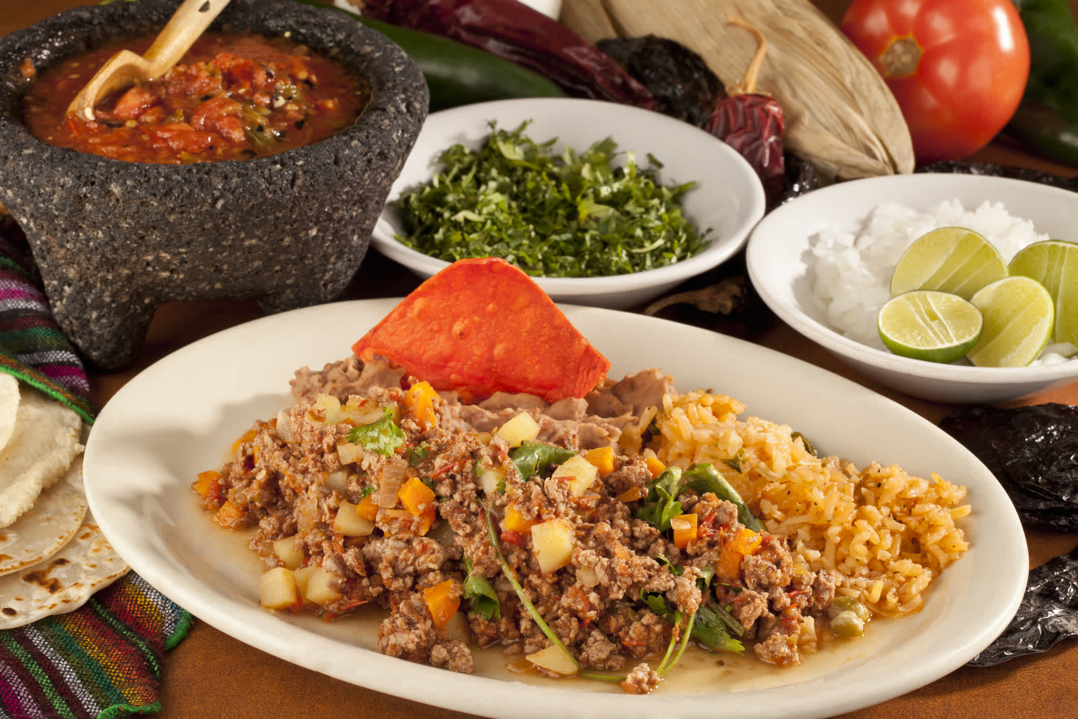 Picadillo - ein Eintopf aus Hackfleisch, Gemüse und Salsa serviert mit Reis und gebratenen Bohnen
