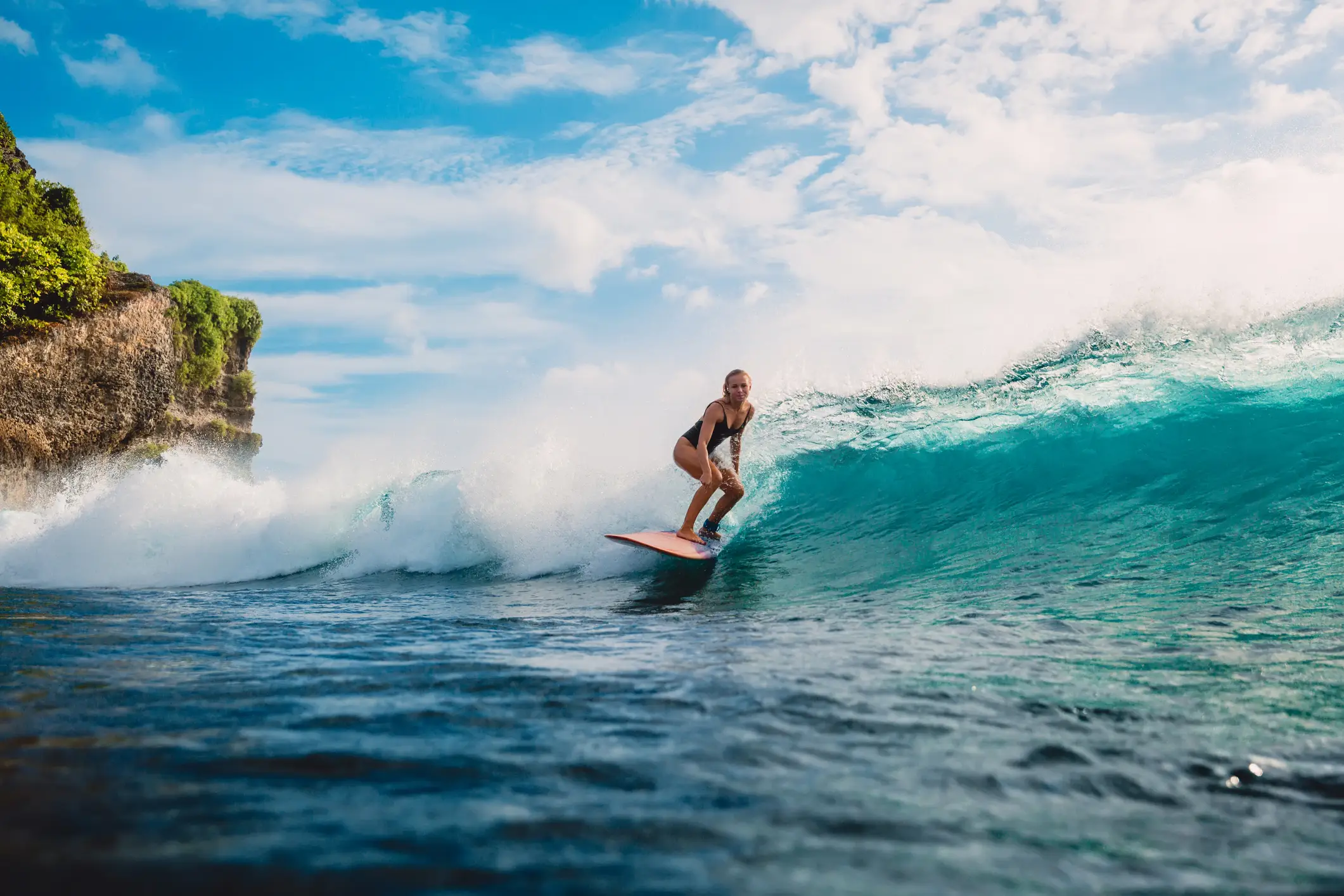 Femme en train de surfer à Tahiti, en Polynésie Française.