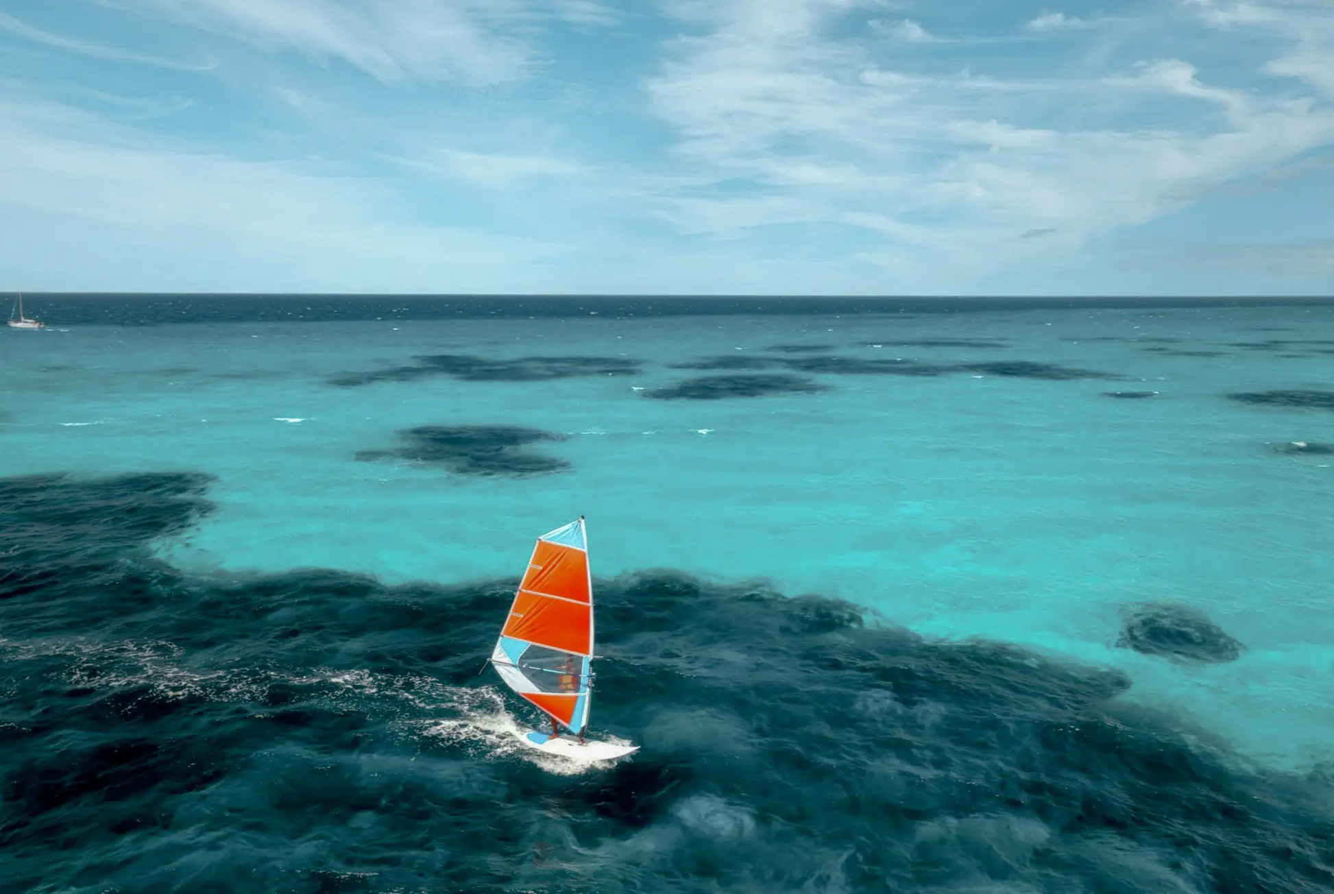 Italy, Sardinia, Sailing Aerial view of windsurfer on blue sea in Sardinia, Italy.