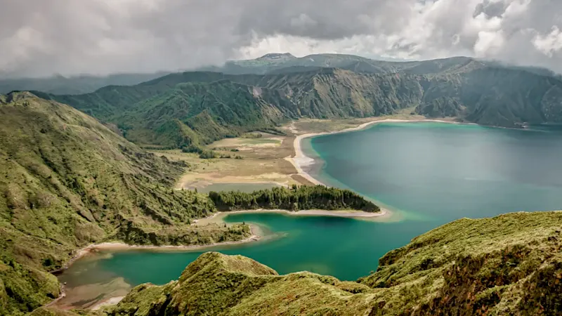 Green mountains with crater lake and sandy beaches. Sete Cidades, Azores, Portugal.