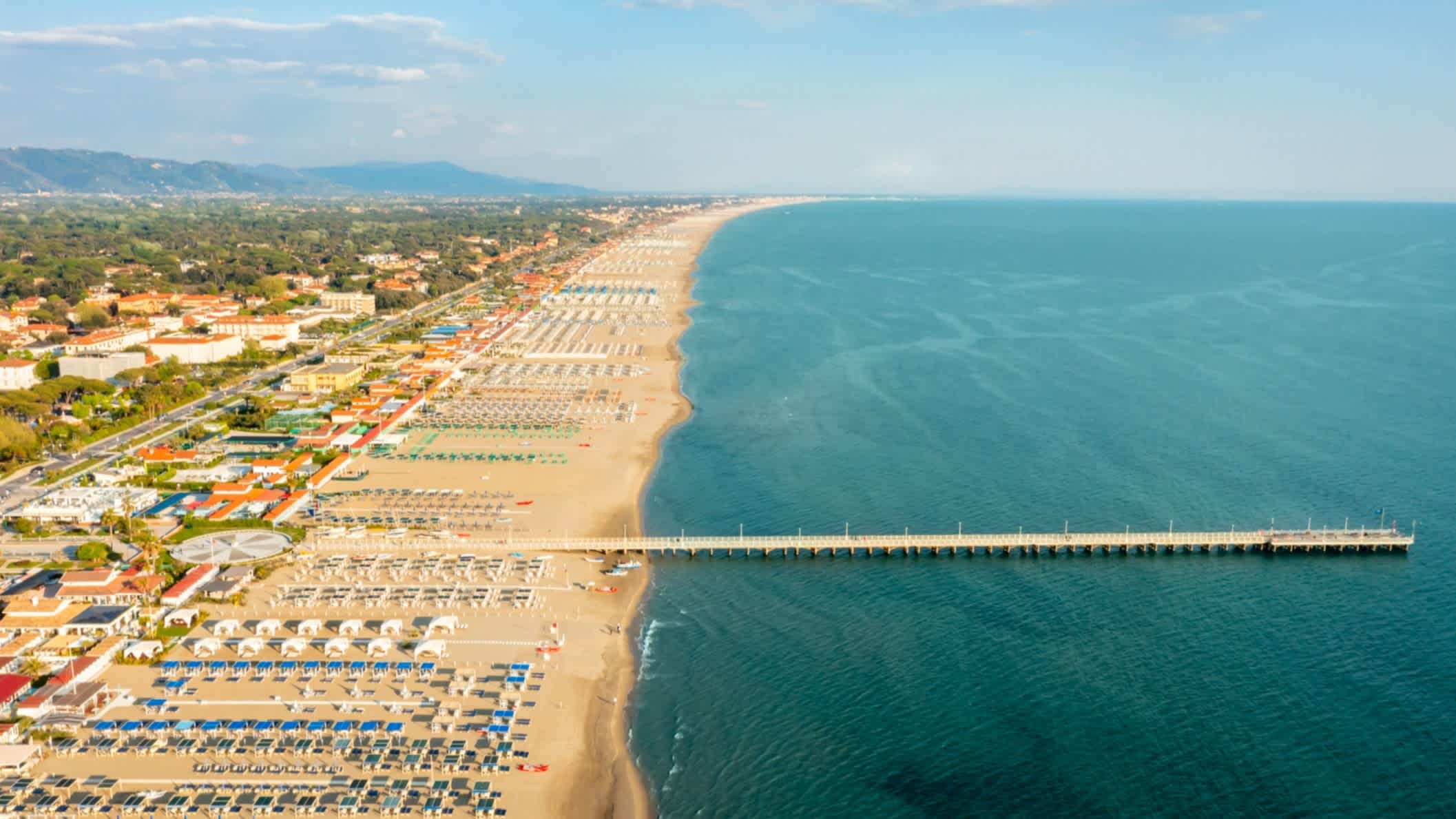 Die Aussicht aus der Luft auf den Forte dei Marmi Pier, Toskana, Italien, das Meer sowie die bebaute und gefüllte Küste.
