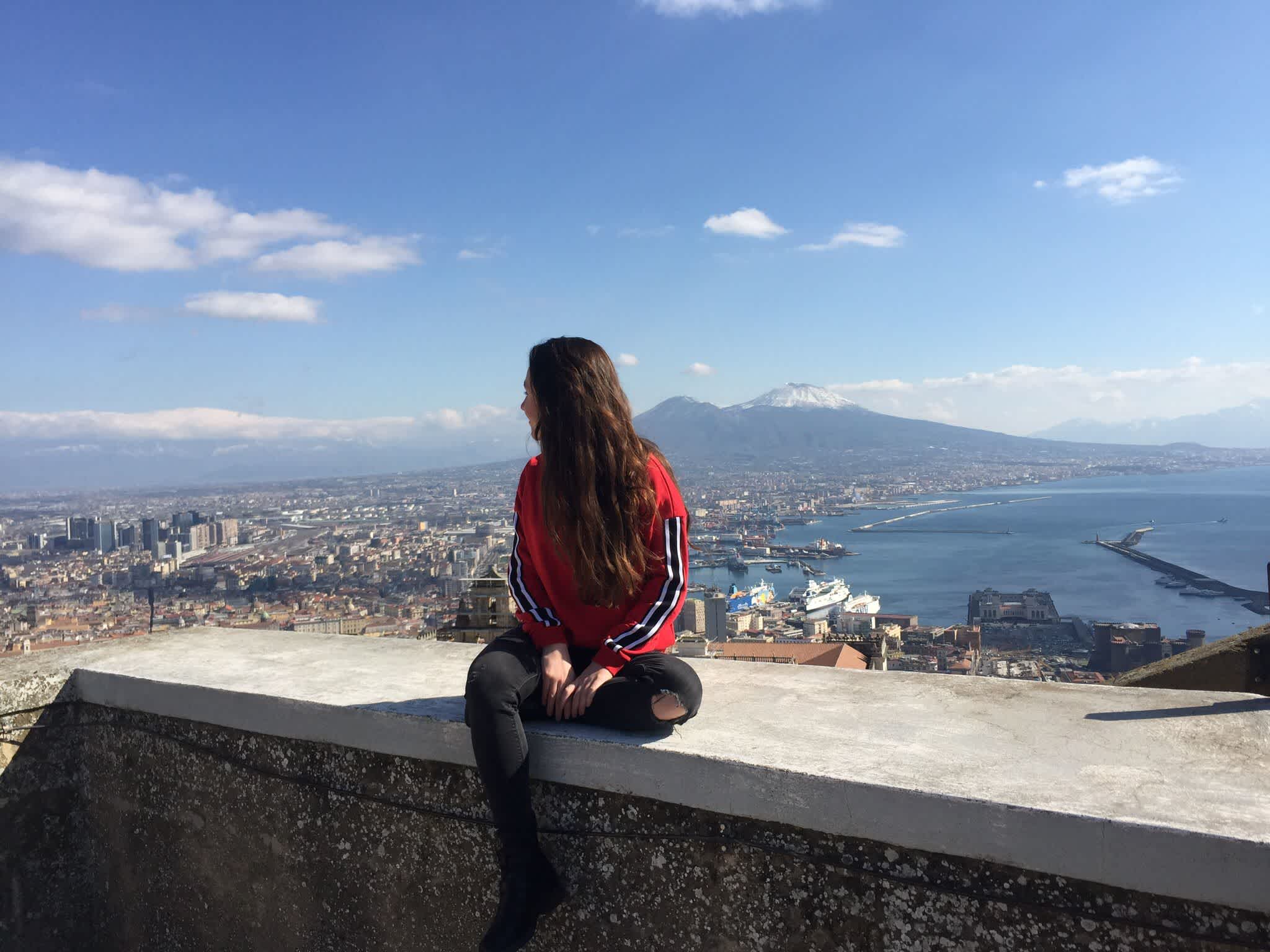 Unsere Reiseexpertin Antonella mit dem Vesuv und Neapel im Hintergrund