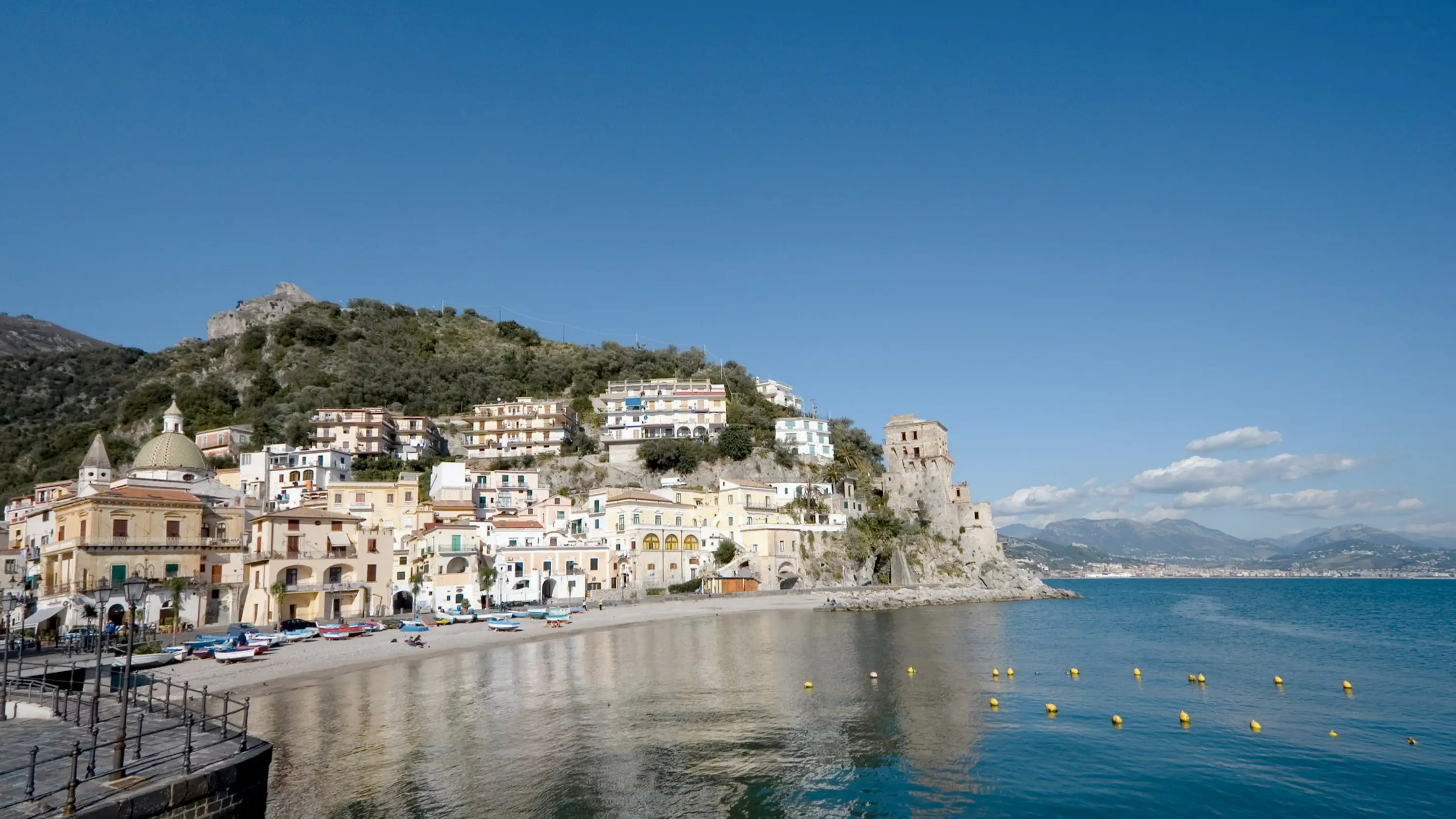 View of the bay of Spiaggia di Cetara with hills and houses in the background