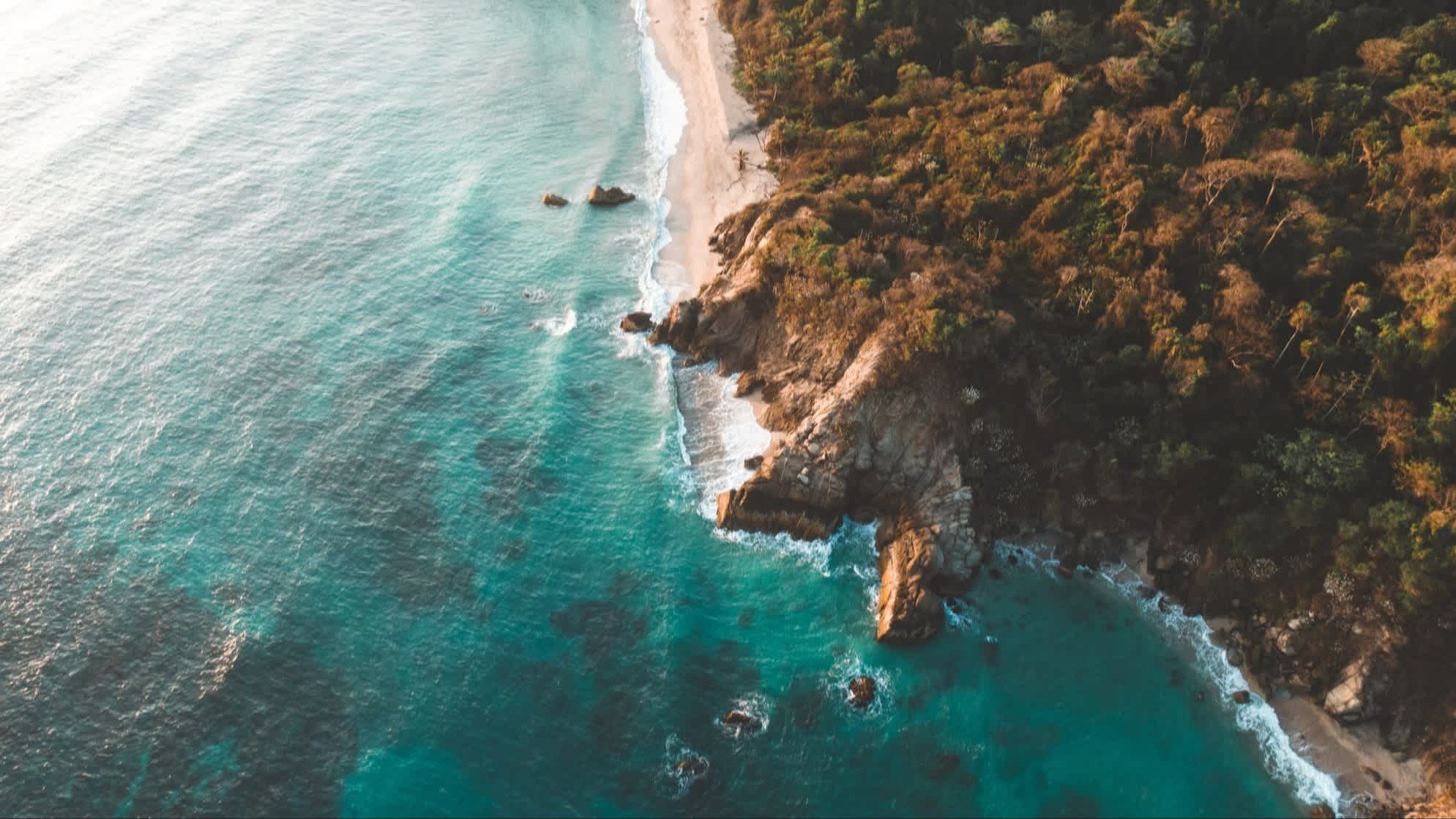 Der Strand Costeño - Guachaca, Magdalena, Kolumbien, mit Blick aus der Luft aus auf den weißen Strand, riesige Felsen sowie die natürliche Vegetation. 