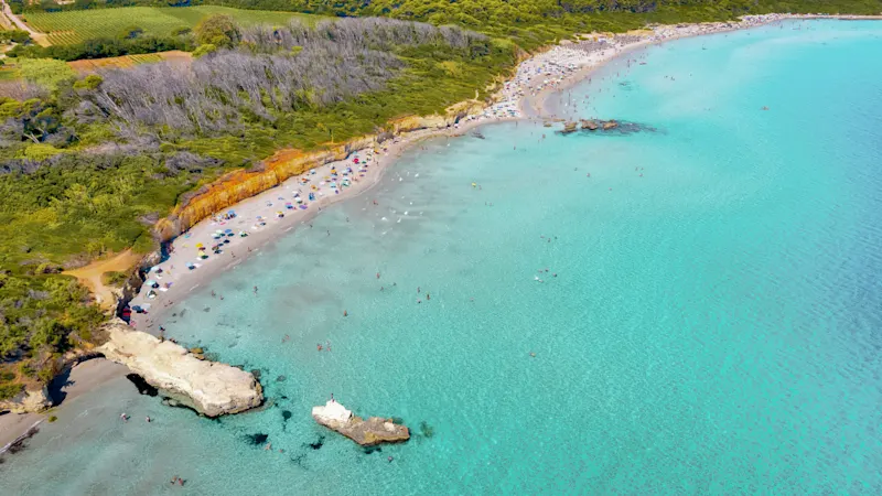 The turquoise blue, wide waters on the beaches of Puglia are calm and inviting, perfect for relaxing days by the sea
