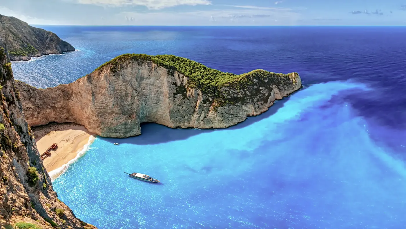 Hidden bay with shipwreck and blue water, Zakynthos, Ionian Islands, Greece.