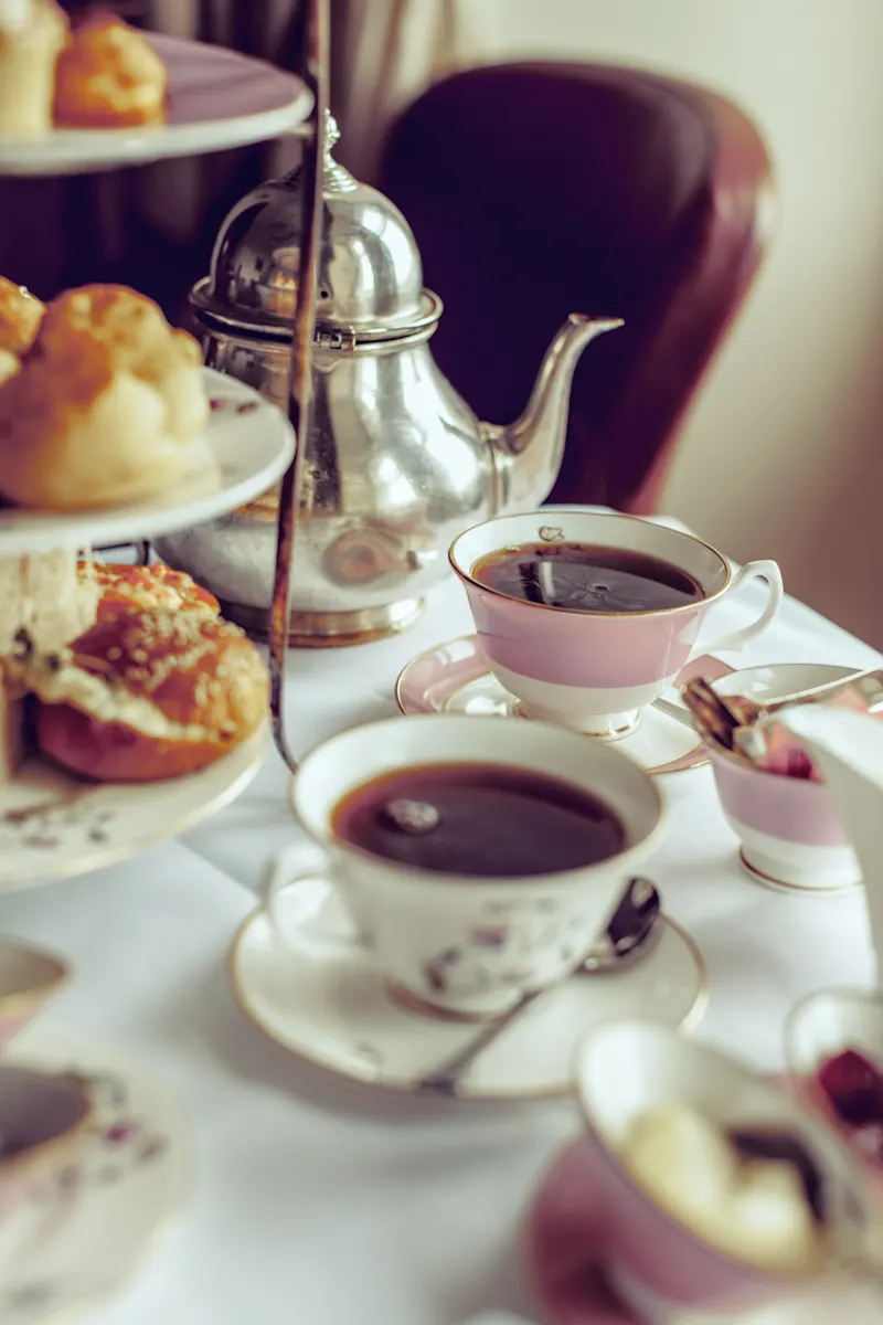 Traditional English tea time with fine pastries and sandwiches, England.
