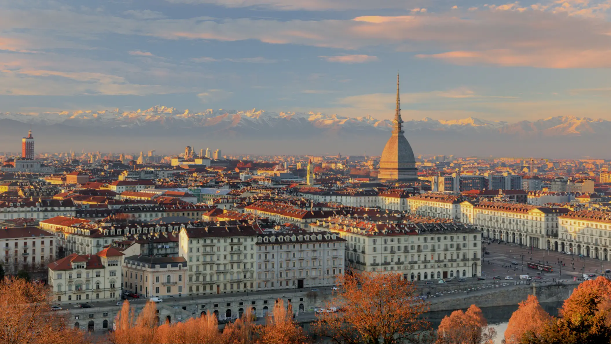 City panorama of Turin with snow-covered mountains in the background