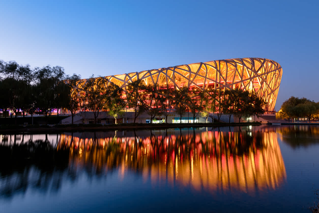 Visit the Beijing National Stadium, pictured here at night, on a tour of China