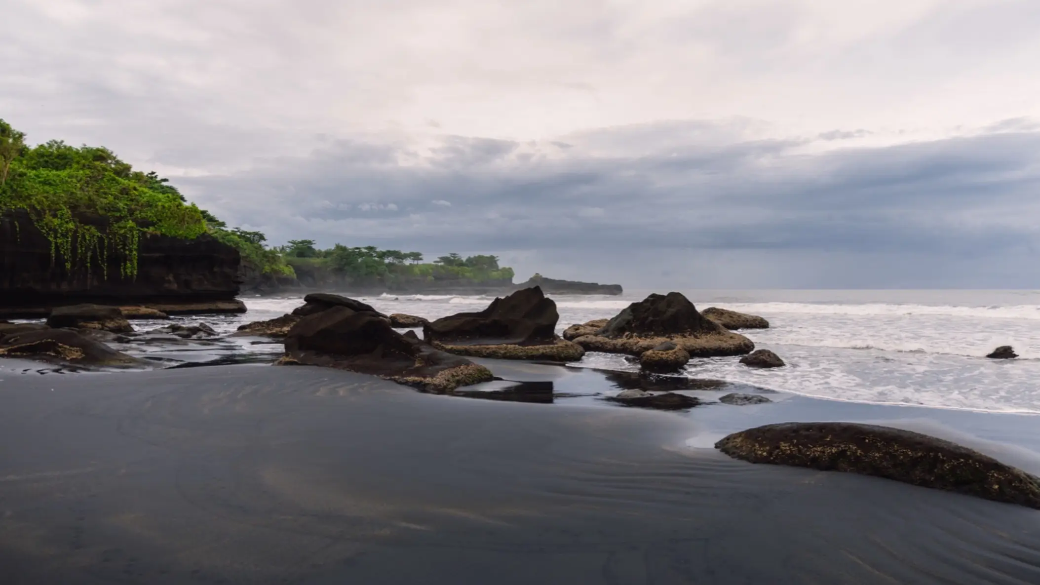 Vue sur le sable noir de la plage volcanique de Balian à Bali, en Indonésie.