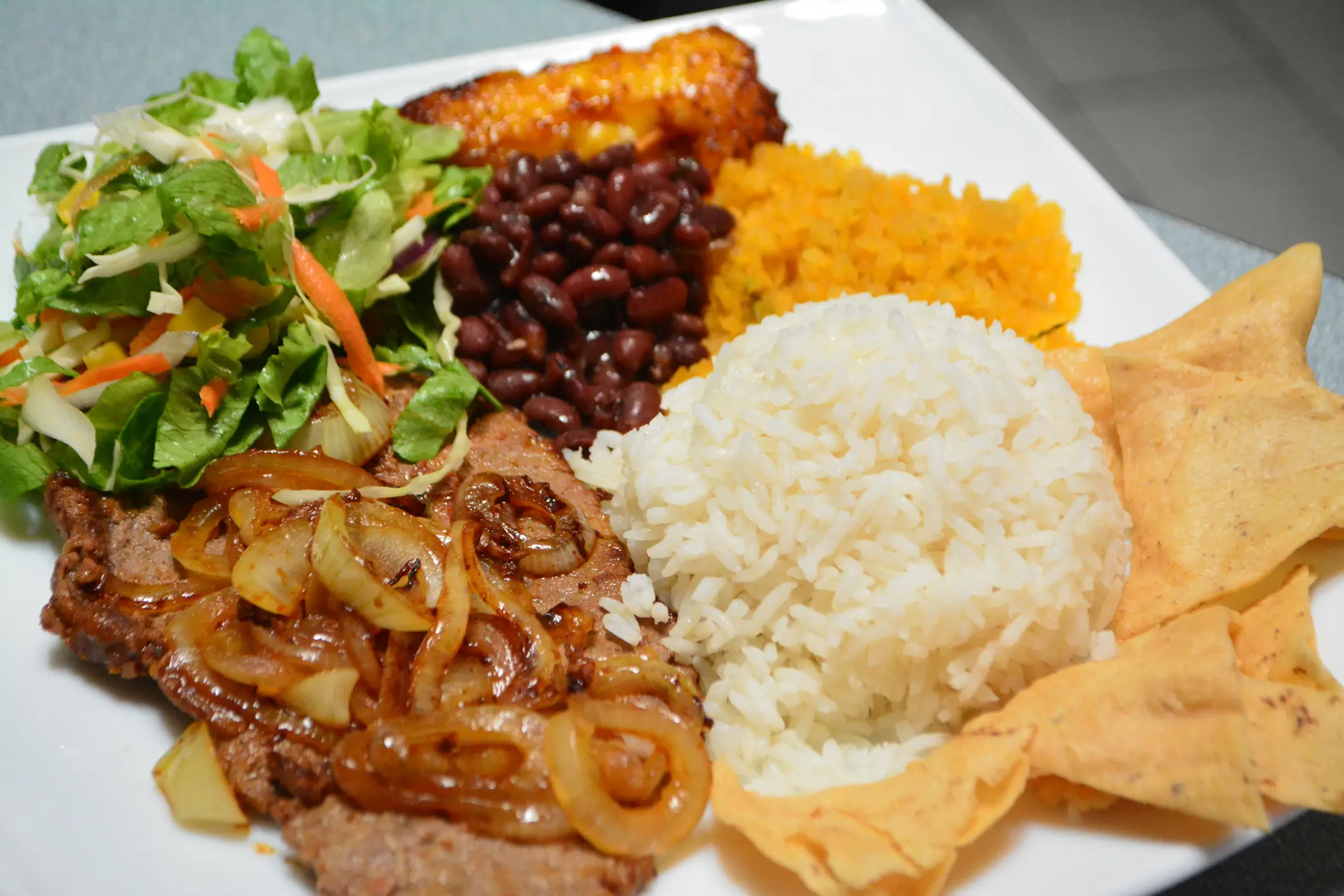 Costa-Ricanisches Essen, Casado Casado - traditionelles Gericht aus Costa Rica Reis, Bohnen, Rindfleisch, gehackte Herzen von Palmensalat und Tortilla-Chips.