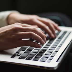 Typing on a laptop