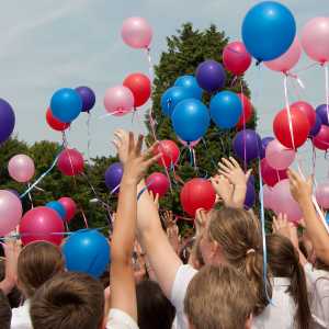 School children flying balloons