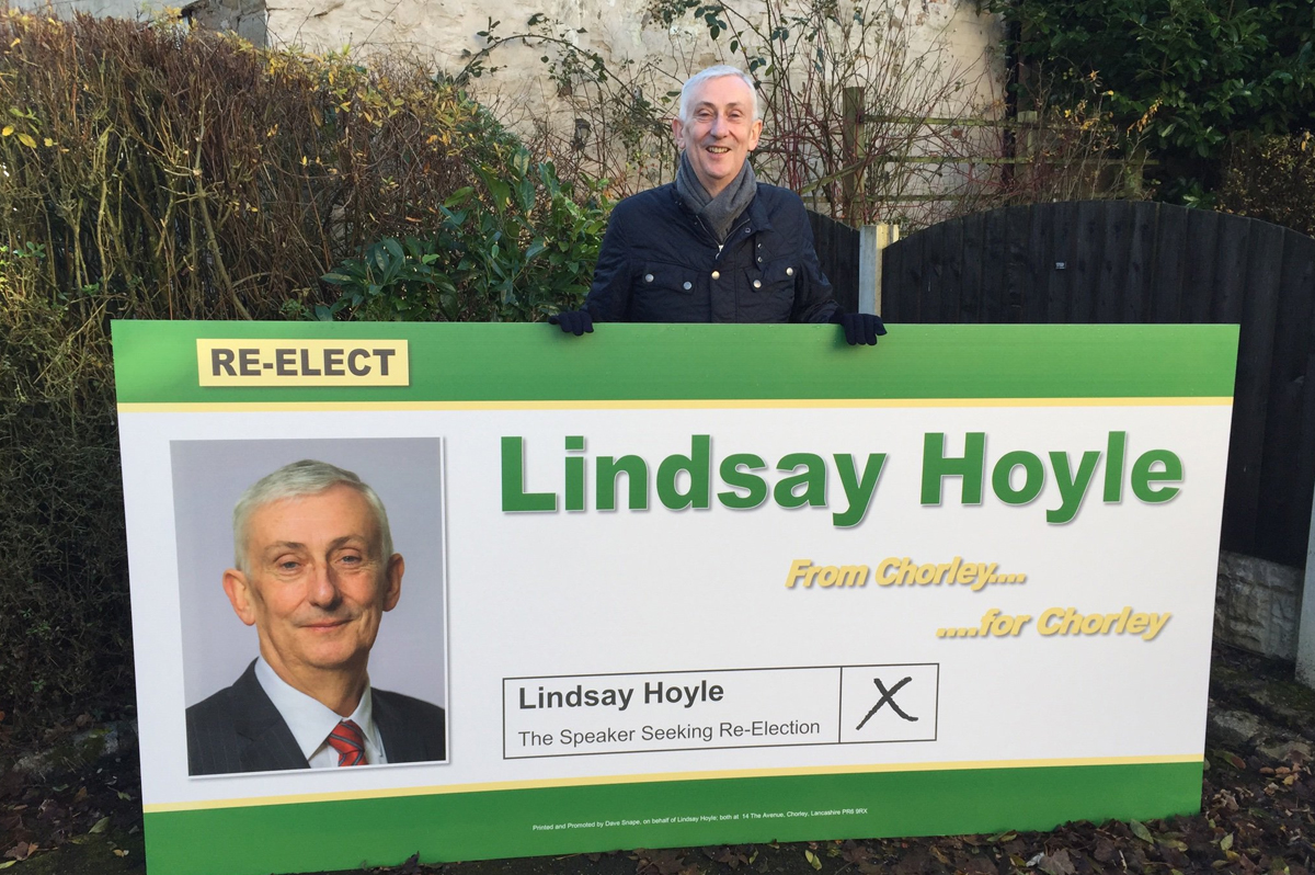 Speaker of the House of Commons, Lindsay Hoyle, holds a sign campaigning for re-election