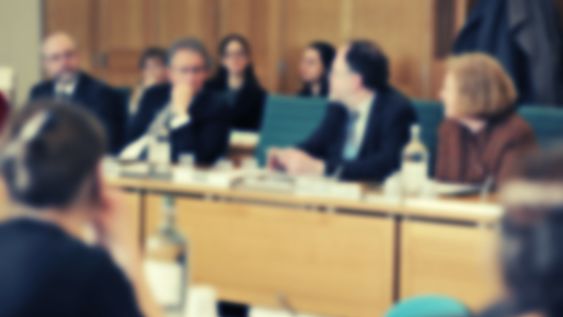 Select committee panel (blurred)