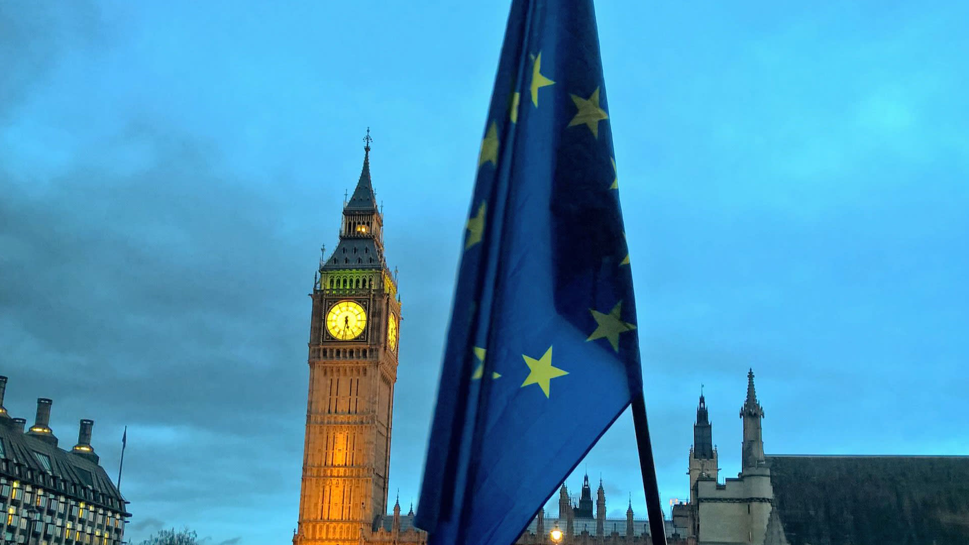 The EU flag in the foreground and Big Ben in the background during a protest in Parliament Square, Westinster.