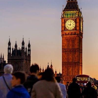 People walking over Westminster Bridge towards the UK Houses of Parliament