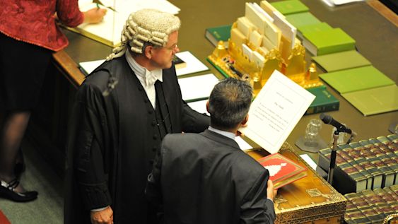 A new Member of Parliament swearing on the Koran in the House of Commons, Westminster
