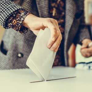 Woman casting a vote in a polling station