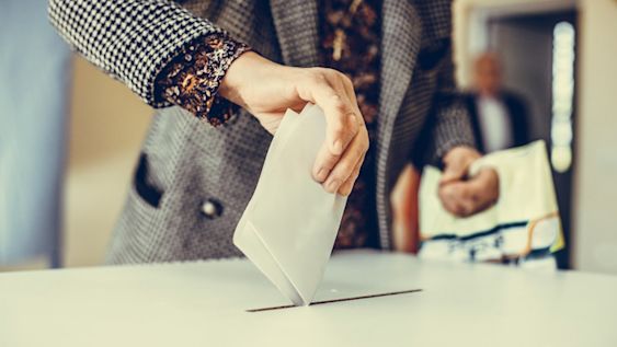Woman casting a vote in a polling station