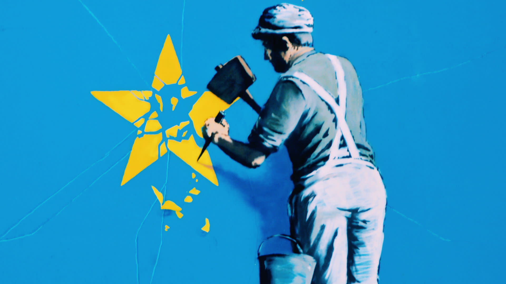 Banksy Brexit mural showing a man chiselling a star from the EU flag