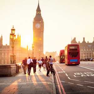 People walking over Westminster Bridge towards the Palace of Westminster, Houses of Parliament