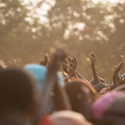 A crowd of people in Ethiopia with their hands up
