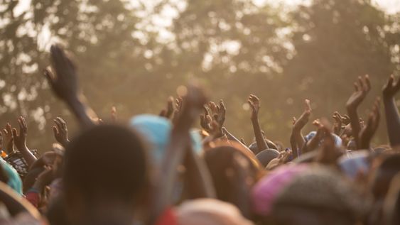 A crowd of people in Ethiopia with their hands up