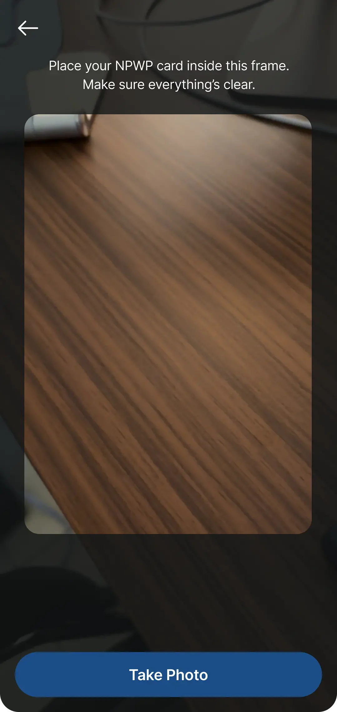 Camera view guiding the user to place their NPWP card inside the frame.