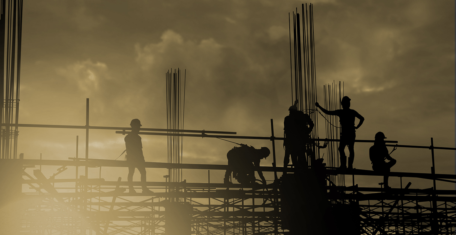 Construction works standing on scaffolding