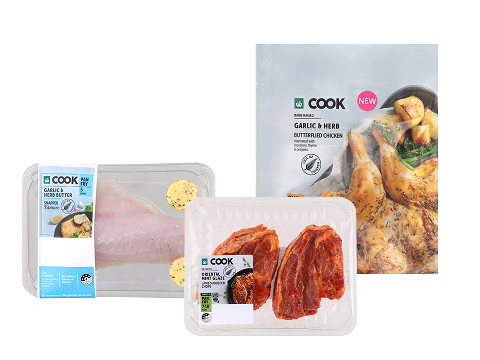An assortment of Woolworths Cook easy dinner options, including garlic herb snapper, glazed lamb chops, and butterflied chicken.