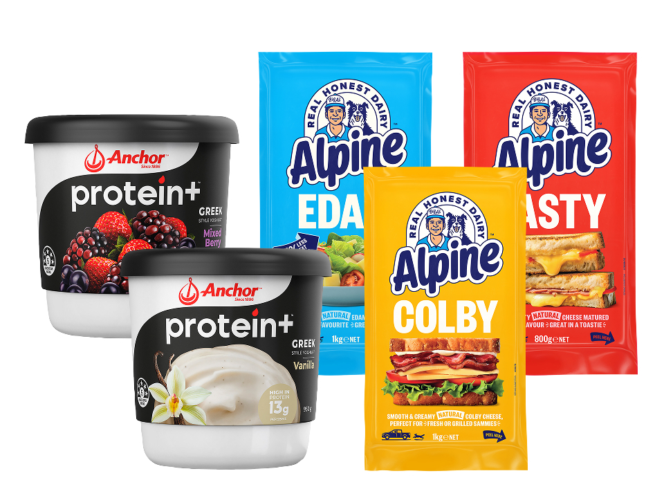 Tubs of Anchor Protein+ Greek yogurt in Mixed Berry and Vanilla alongside blocks of Alpine Edam, Colby, and Tasty cheese.